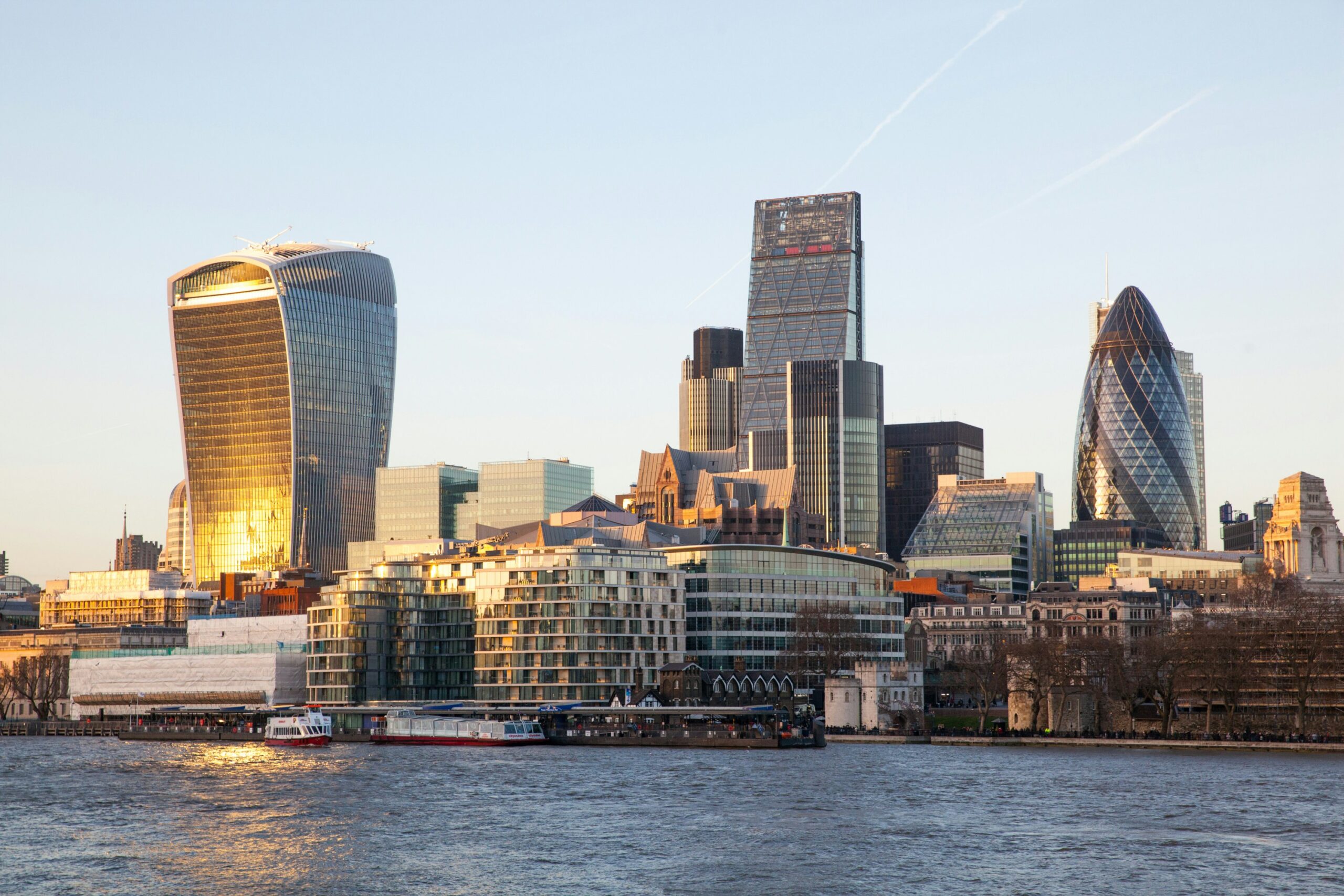 UK Economy with the City of London skyline at sunset.